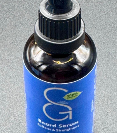 Shea Goodness beard serum in a dark glass bottle with a pipette dropper for easy and accurate measurements.