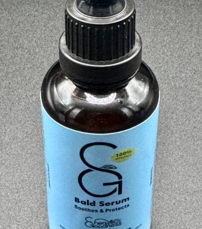 Shea Goodness Bald Head serum in a dark glass bottle with a pipette dropper for accurate measurements